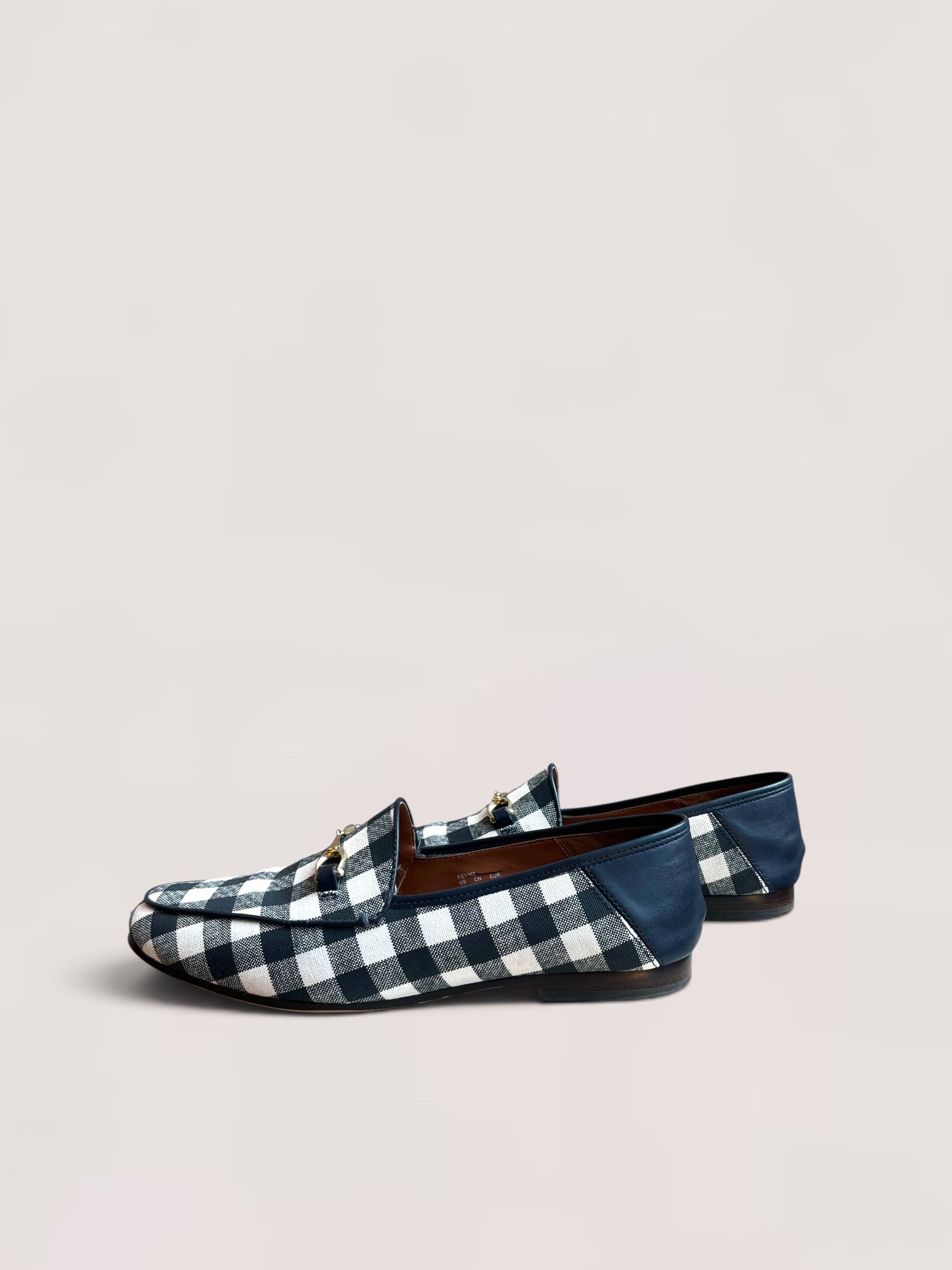 Black and white checked Coach loafers