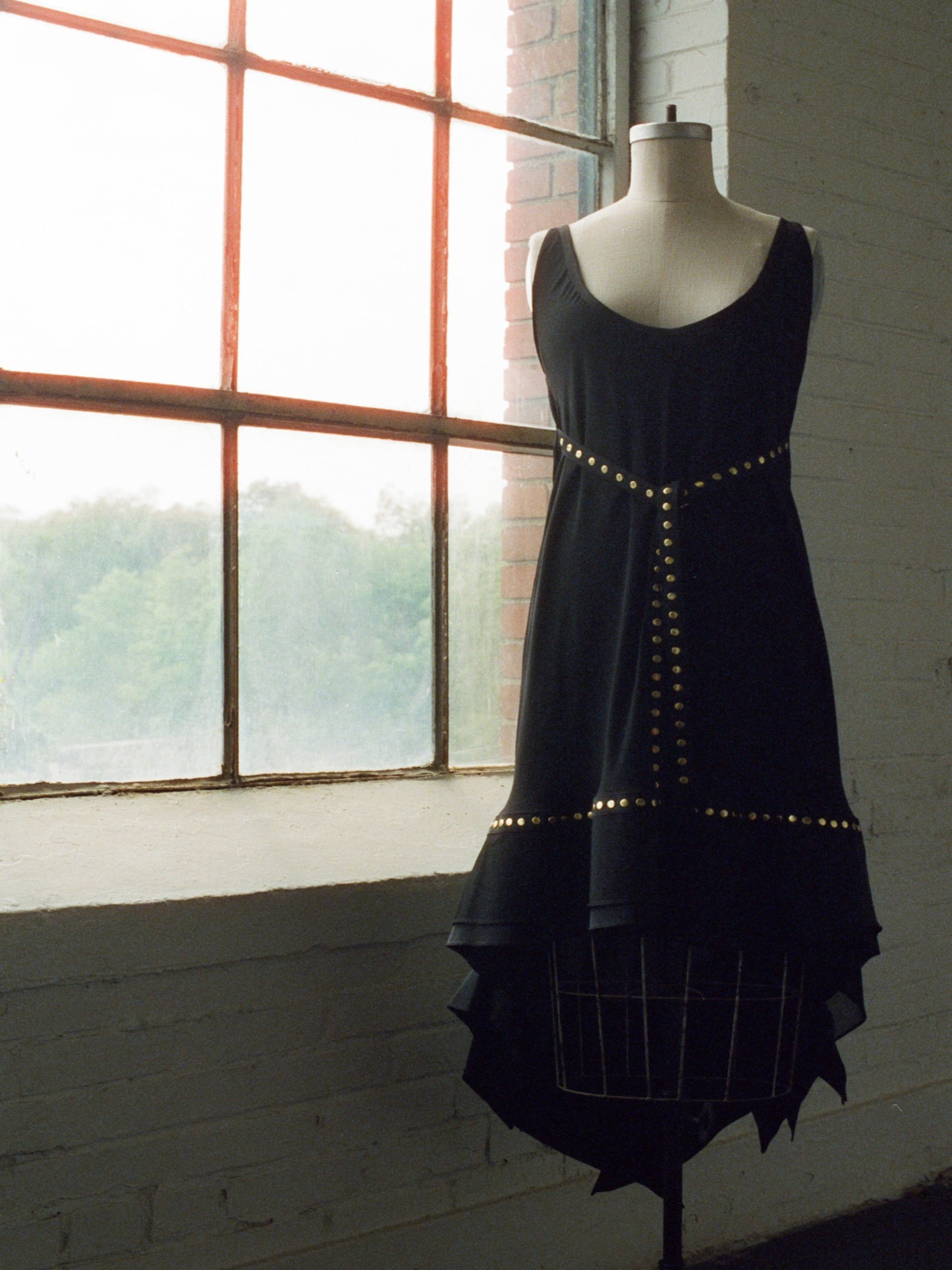 Black dress with gold studs and ruffles Marie Saint Pierre